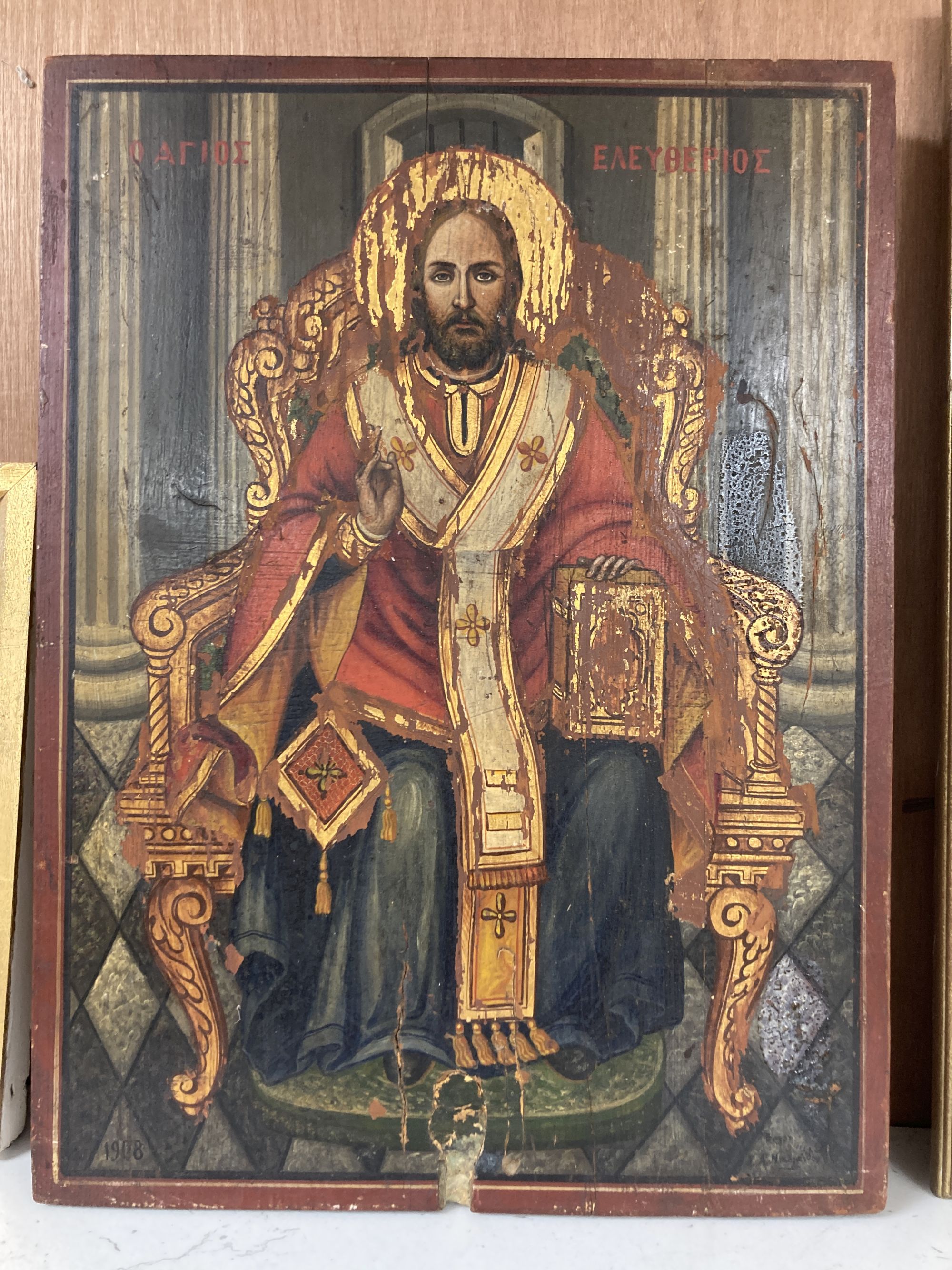 An early 20th century tempera on pine icon depicting Christ seated upon a throne, dated 1908, 40 x 30cm